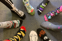 feet in a circle wearing wild socks