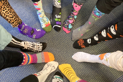 feet in a circle wearing wild socks