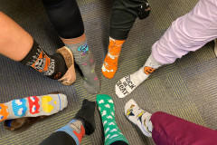feet in a circle wearing wild socks
