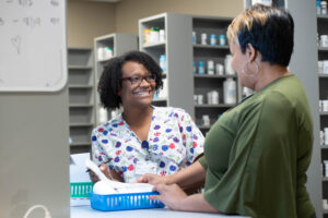 Pharmacy staff member greeting a client